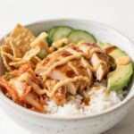 spicy honey-ginger chicken bowl with yum yum sauce over rice