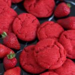Strawberry sugar cookie with a cracked red surface, dusted with sparkling sugar